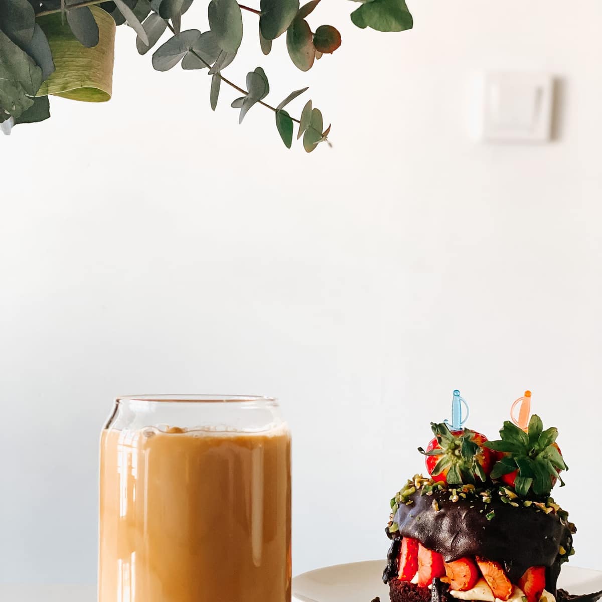 Iced coffee served with a chocolate dessert