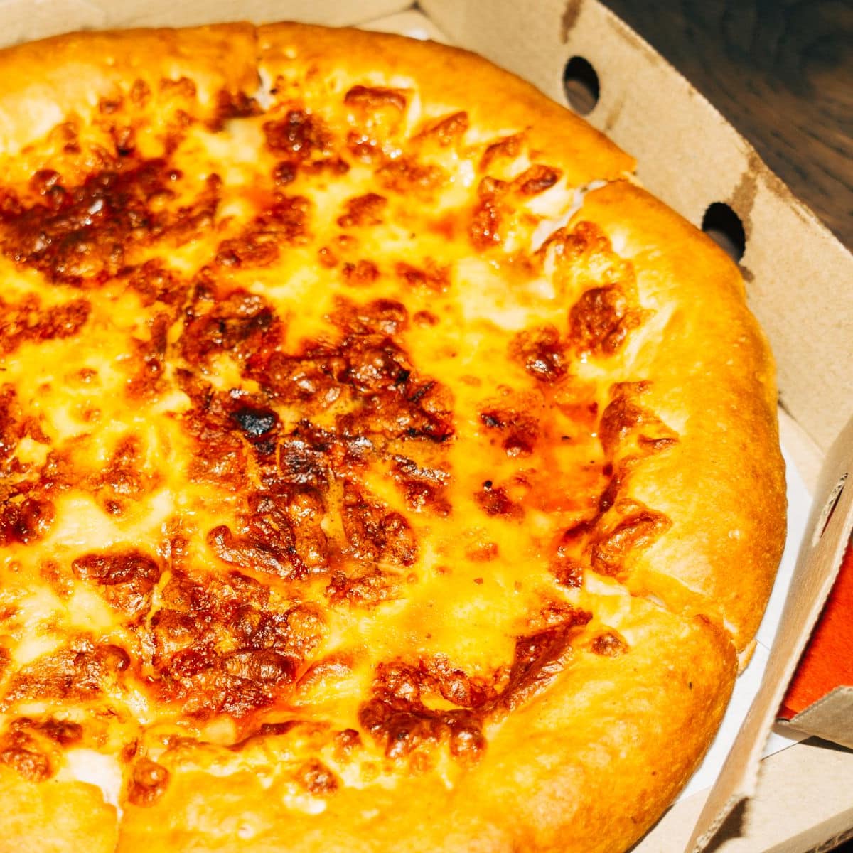 Stuffed crust cheese pizza in an open box